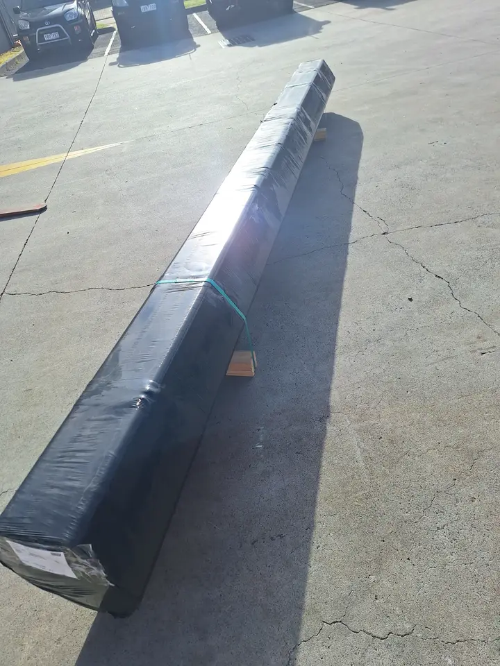 Long wrapped metal beam on ground